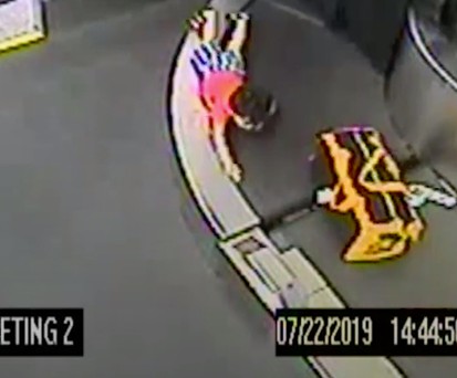 Small boy trapped on luggage belt