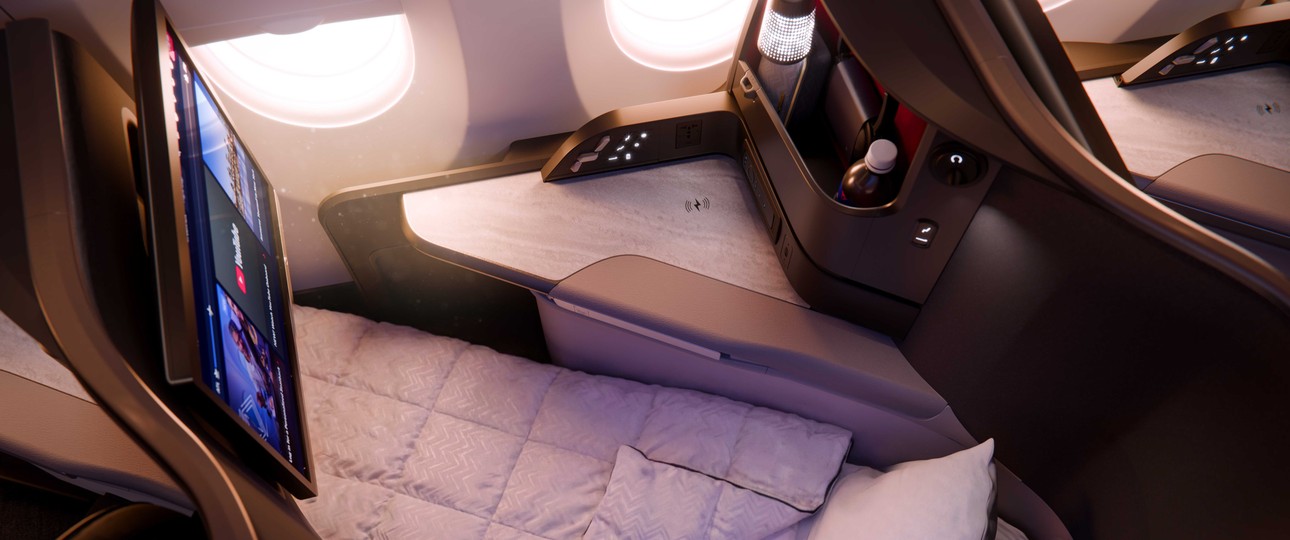 Ein Sitz der Delta One Suite im A350-1000 als Bettmodus mit Decke