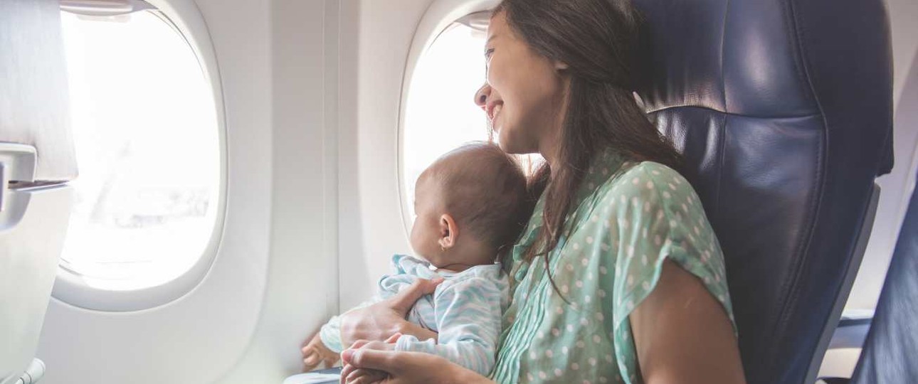 Eine Mutter mit ihrem Baby im Flugzeug: Babys sollen in den USA künftig besser gesichert werden.
