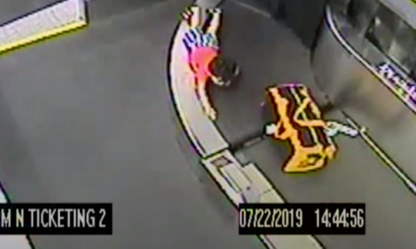 Small boy trapped on luggage belt