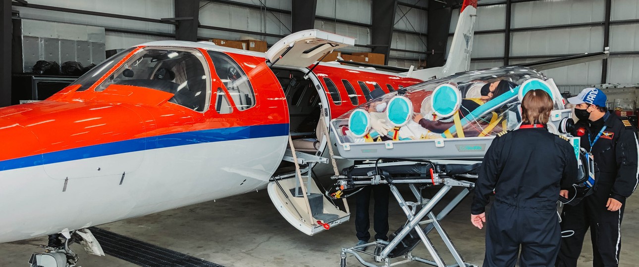 Ein Epishuttle wird in einen Ambulanzflieger verladen: Die Isolier-Liege schützt Besatzungen vor Ansteckungen.