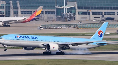 Boeing 777-300 von Korean Air, dahinter ein Jet von Asiana: Bald in einem Terminal.