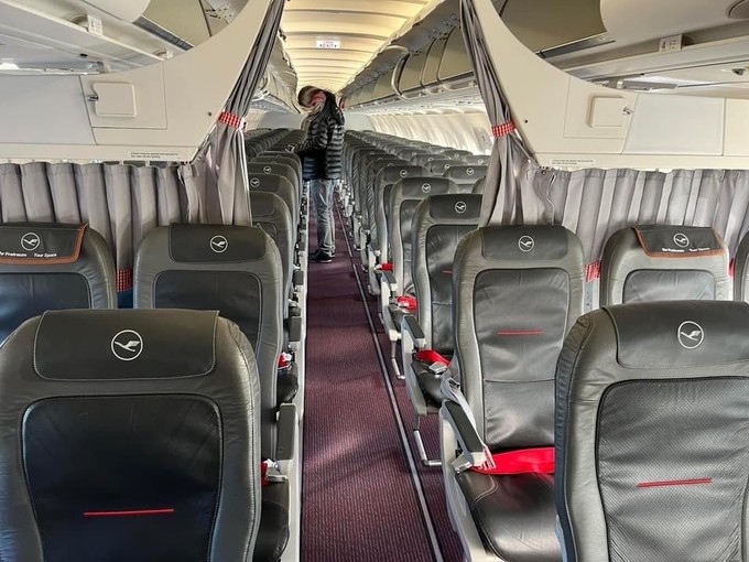 Rote Gurte, Trachten-Vorhanghalter: So sieht es im Airbus A319 von Lufthansa Cityline aus.